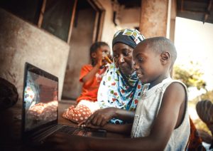 mother and child on laptop in remote area