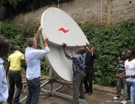 connecting communities men installing satellite dish