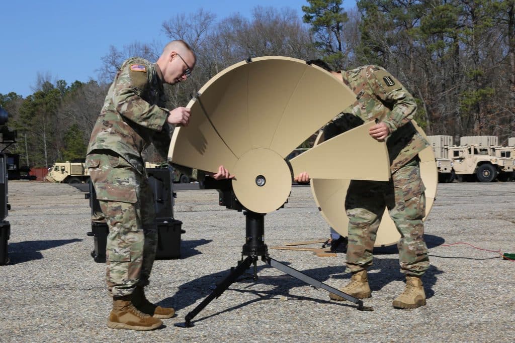 soldiers setting up satellite managed s service dish