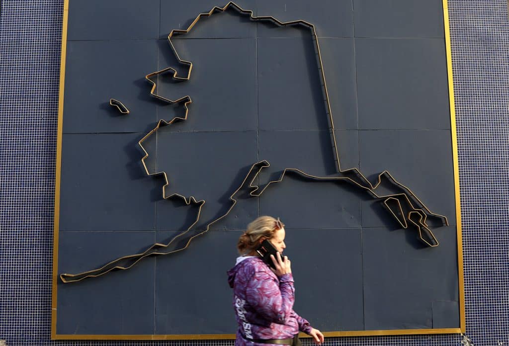 woman using multi-orbit satellite serviced phone